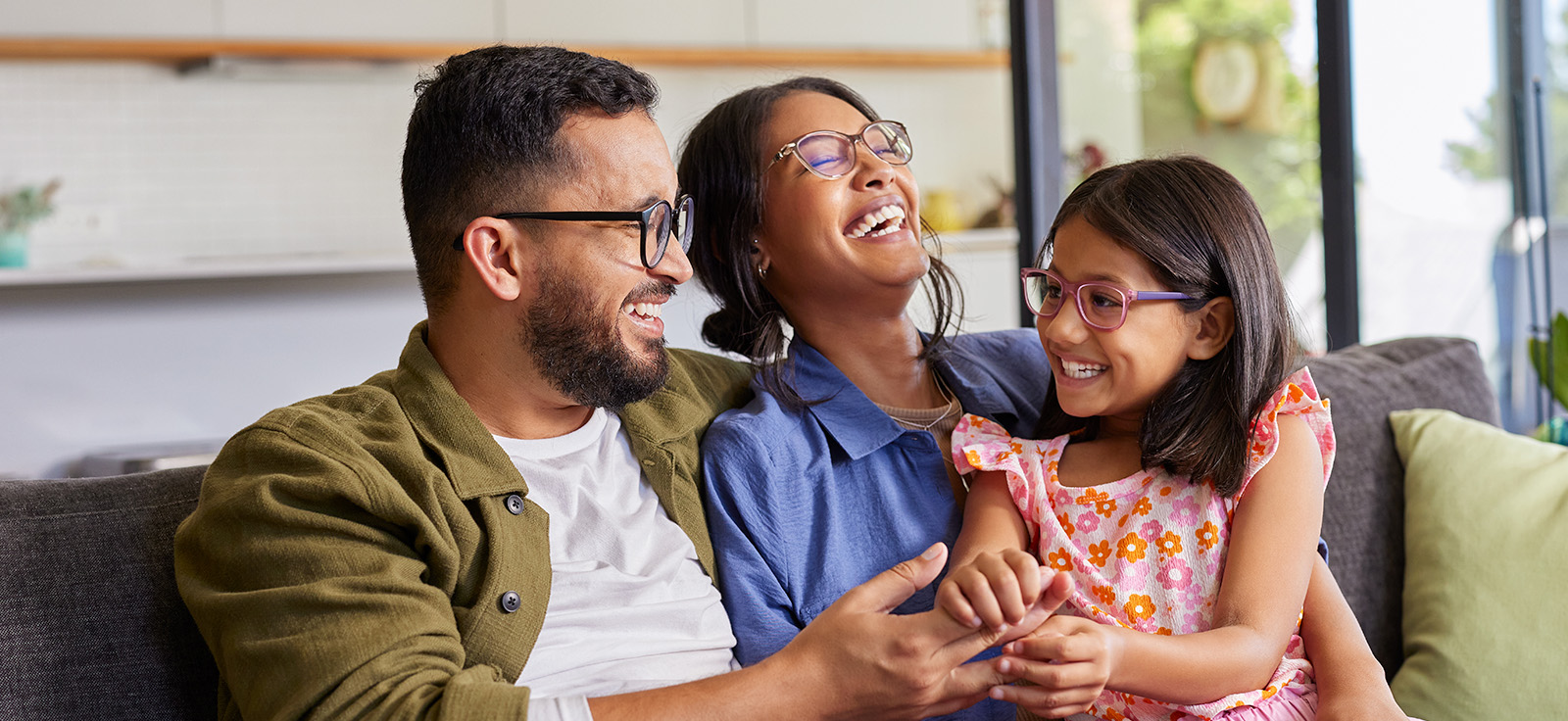 family laughing together on the couch