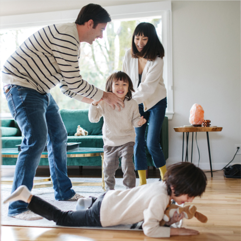 mother and father in their living room with son and daughter